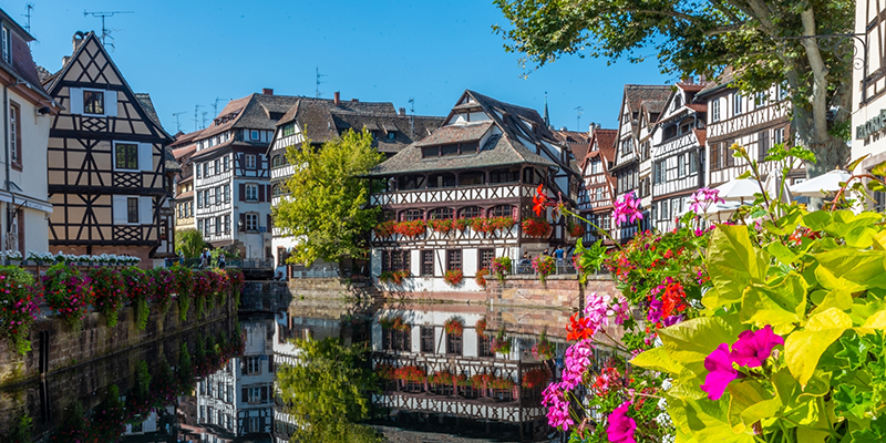 Buildings line a river.