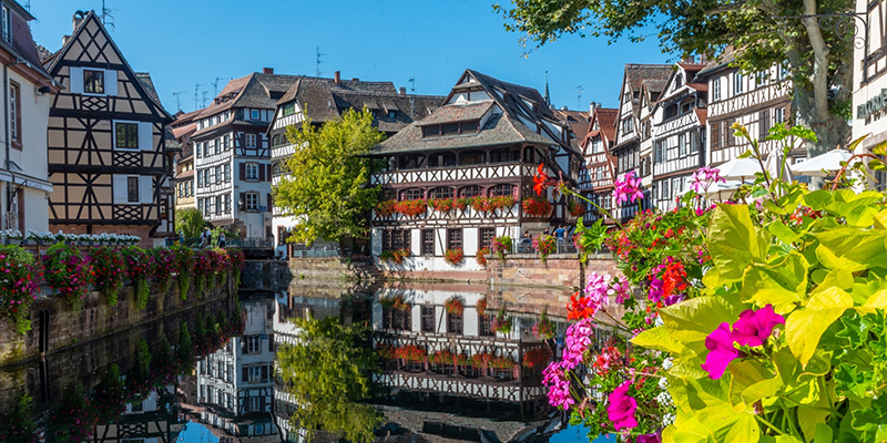 Strasbourg, France, a view of a body of water with buildings in the background.